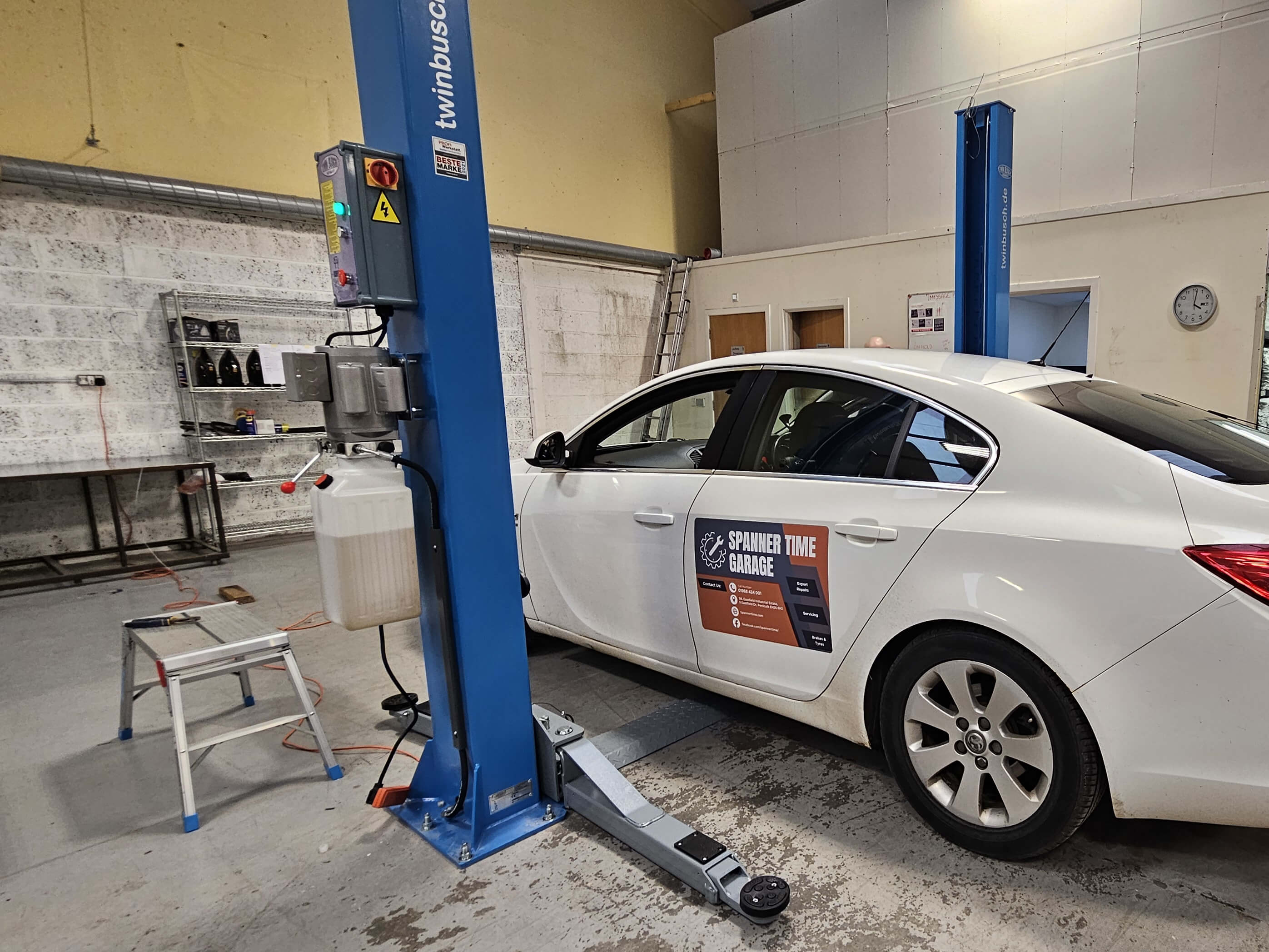 A car on the new lift at Spanner Time Garage
