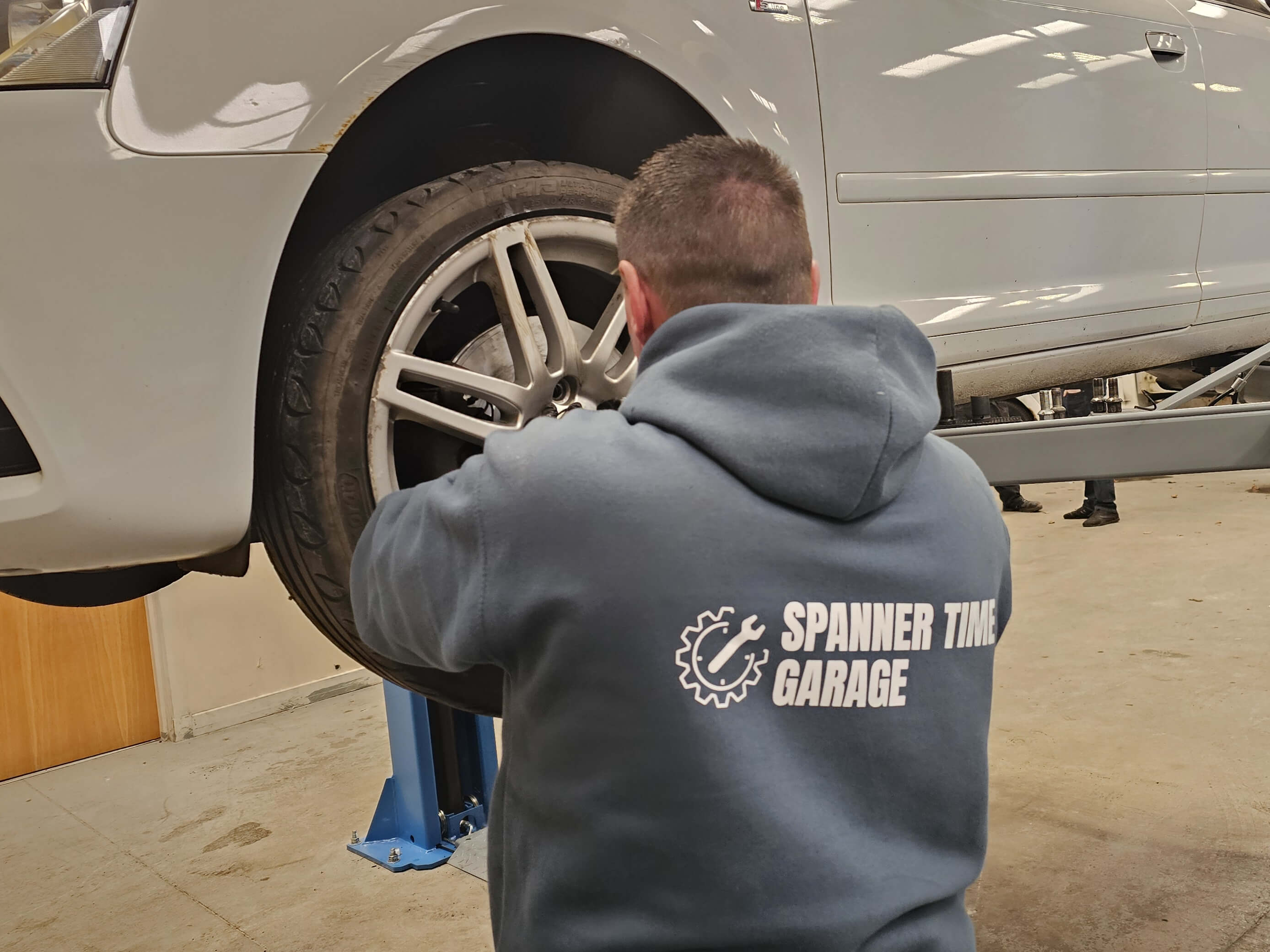 A technician working on a vehicle at Spanner Time Garage